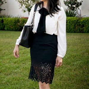 Black pencil skirt with laser cutout hem details